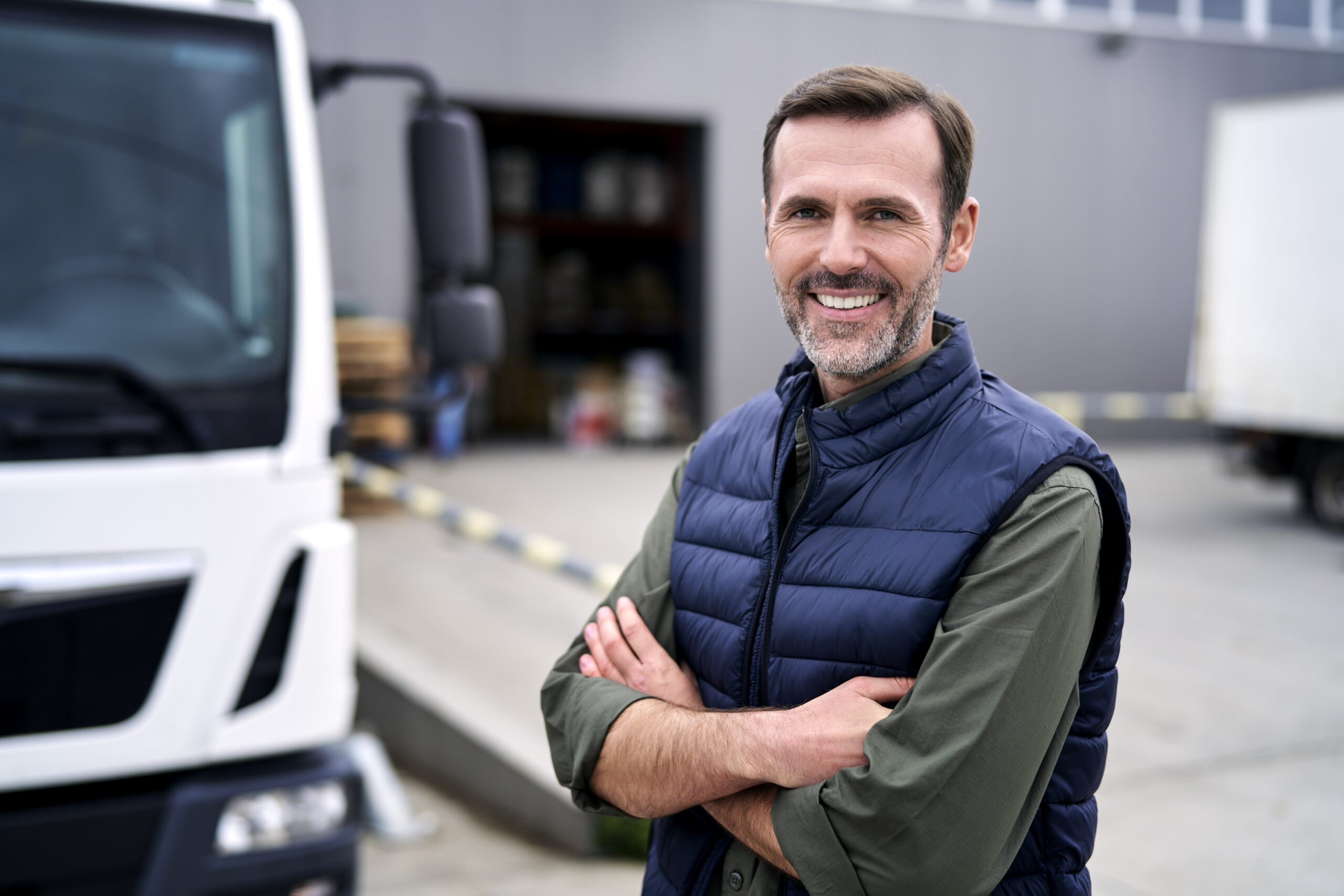 Portrait of caucasian mature man in front of warehouse